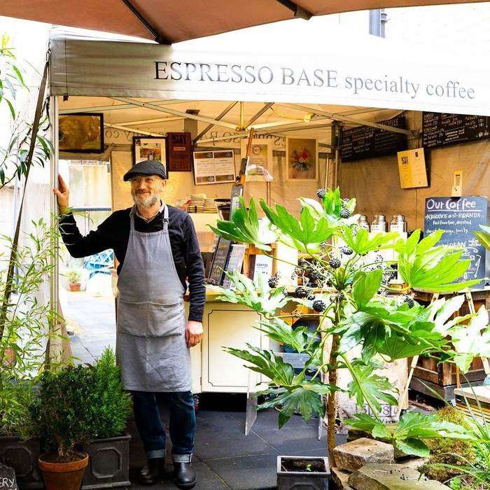 Gennaro De Mattia standing at his espresso cart in the churchyard garden